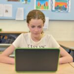 student using laptop reading