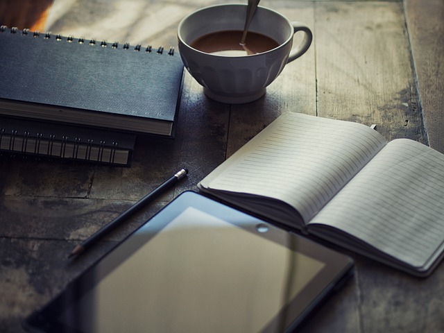 Teenager writing in a journal with a thoughtful expression.